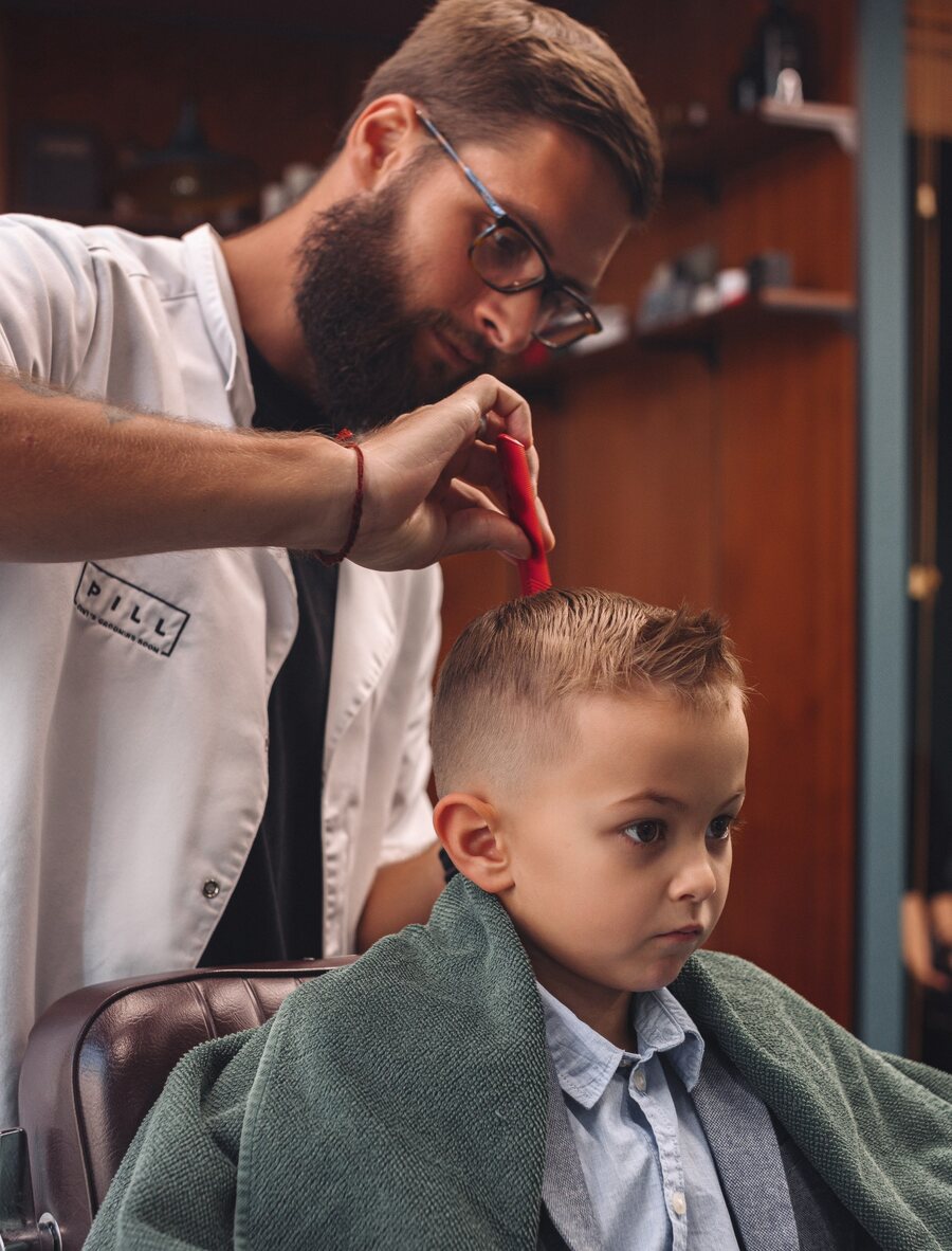 Boy’s haircut in the barber chair